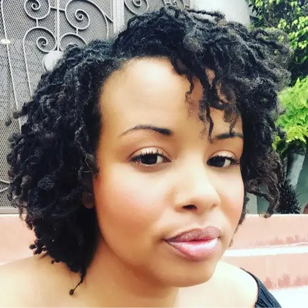 Short curly locs outdoors — growing into the journey