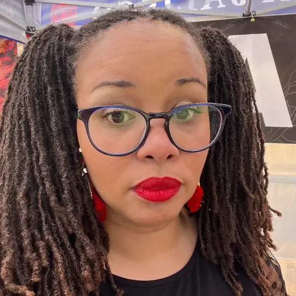 Mature dark locs styled confidently — owning the crown